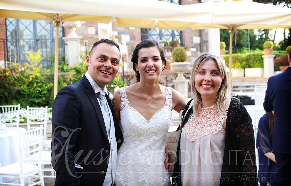 A newly married couple celebrates with Valeria Sargentoni, one of the best Italian wedding singers and vocalists-DJs, by Romadjpianobar music services in Italy.
